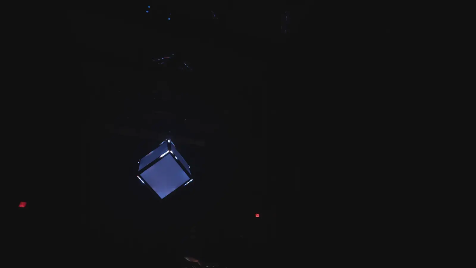 The Quantum Qube at the centre of a wide fan of violet beams in a darkened venue.
